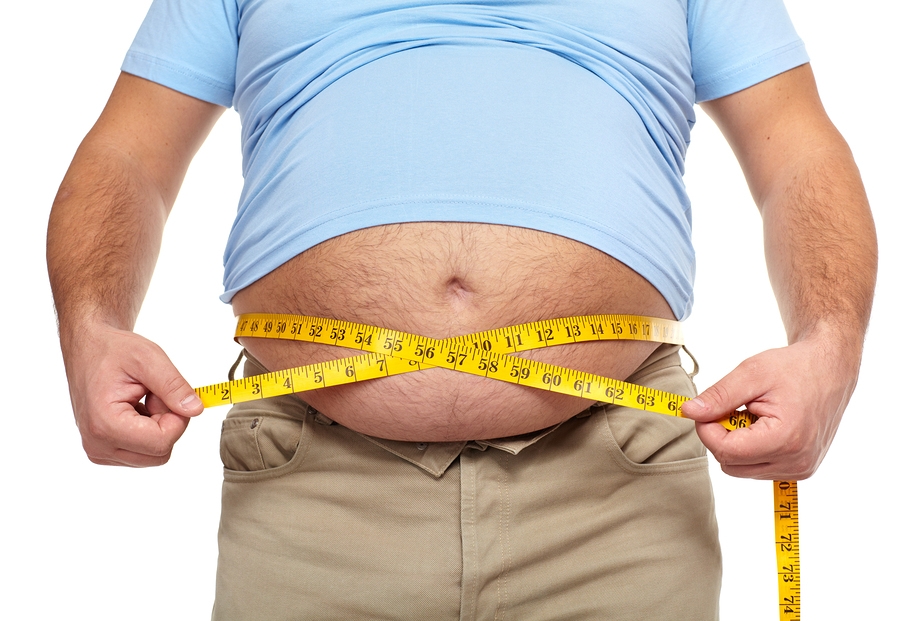 Obese man with tape measure around waist
