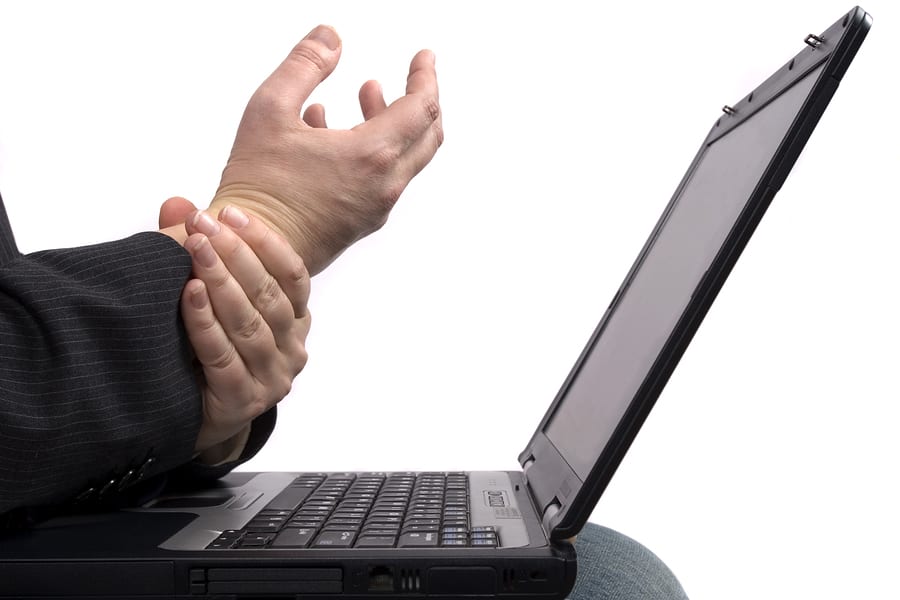 Person at laptop appearing to have RSI in their wrists