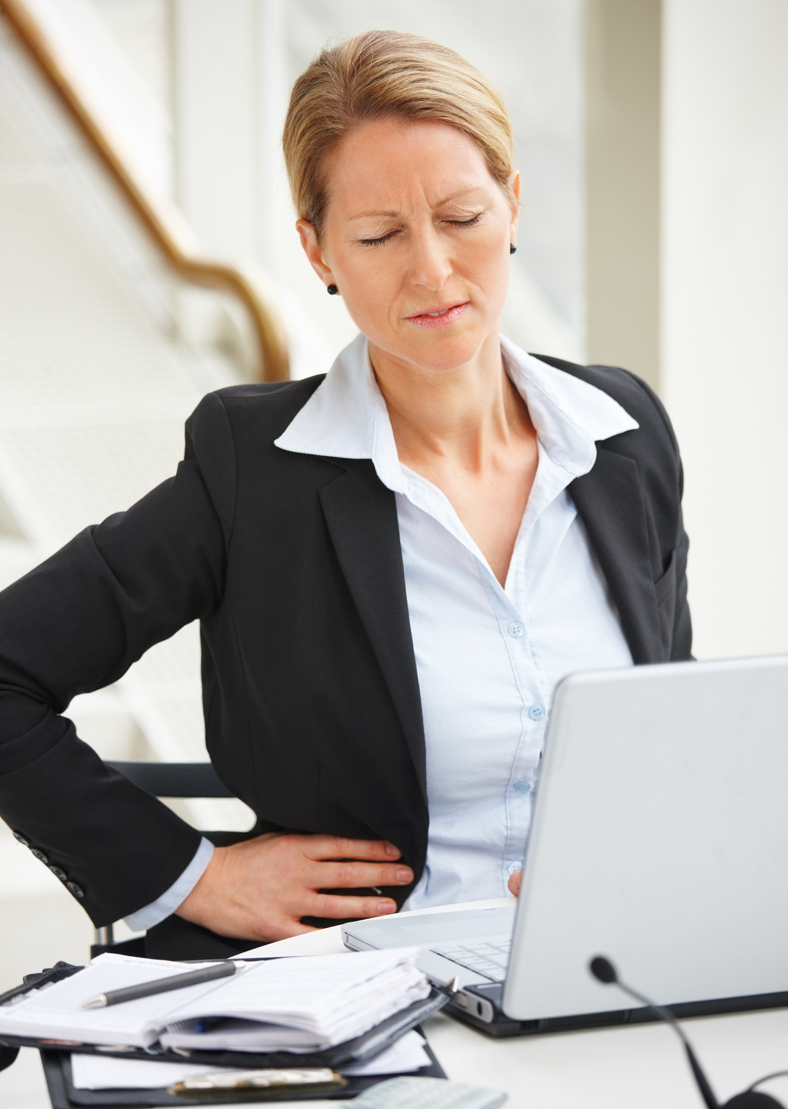 Woman appearing to be suffering from lower back pain