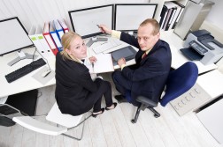 Office colleagues at a computer workstation