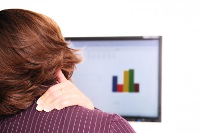 Woman with neck pain sitting at a computer