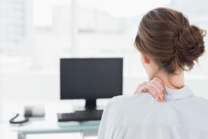 Businesswoman with neck or shoulder pain