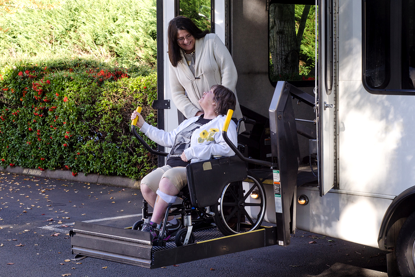 Wheelchair user being helped from bus