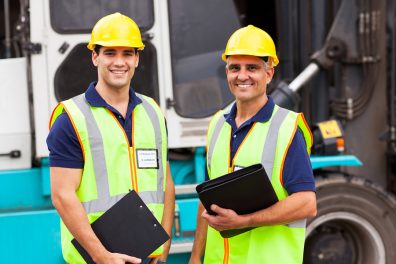 Workers standing in front of a forklift