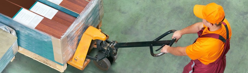 Man performing push/pull manual handling task with a pallet truck.