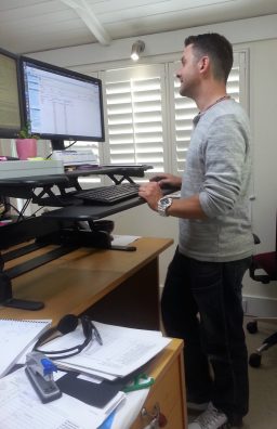 Steve standing at his desk